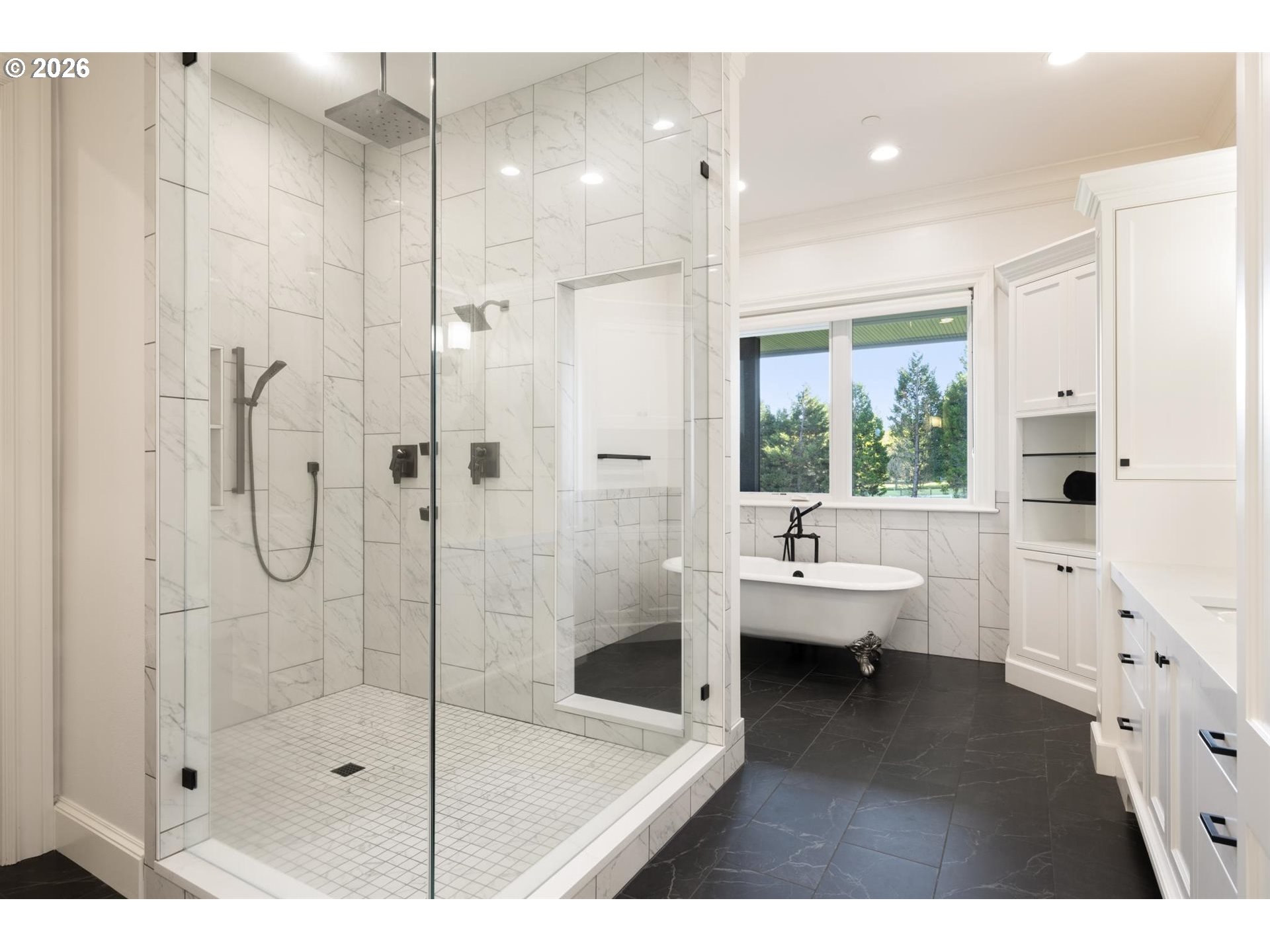 19600 Northwest 55th Avenue Ridgefield, WA 98642 - Photo 22 of 48 a bathroom with a glass shower door and a bathtub