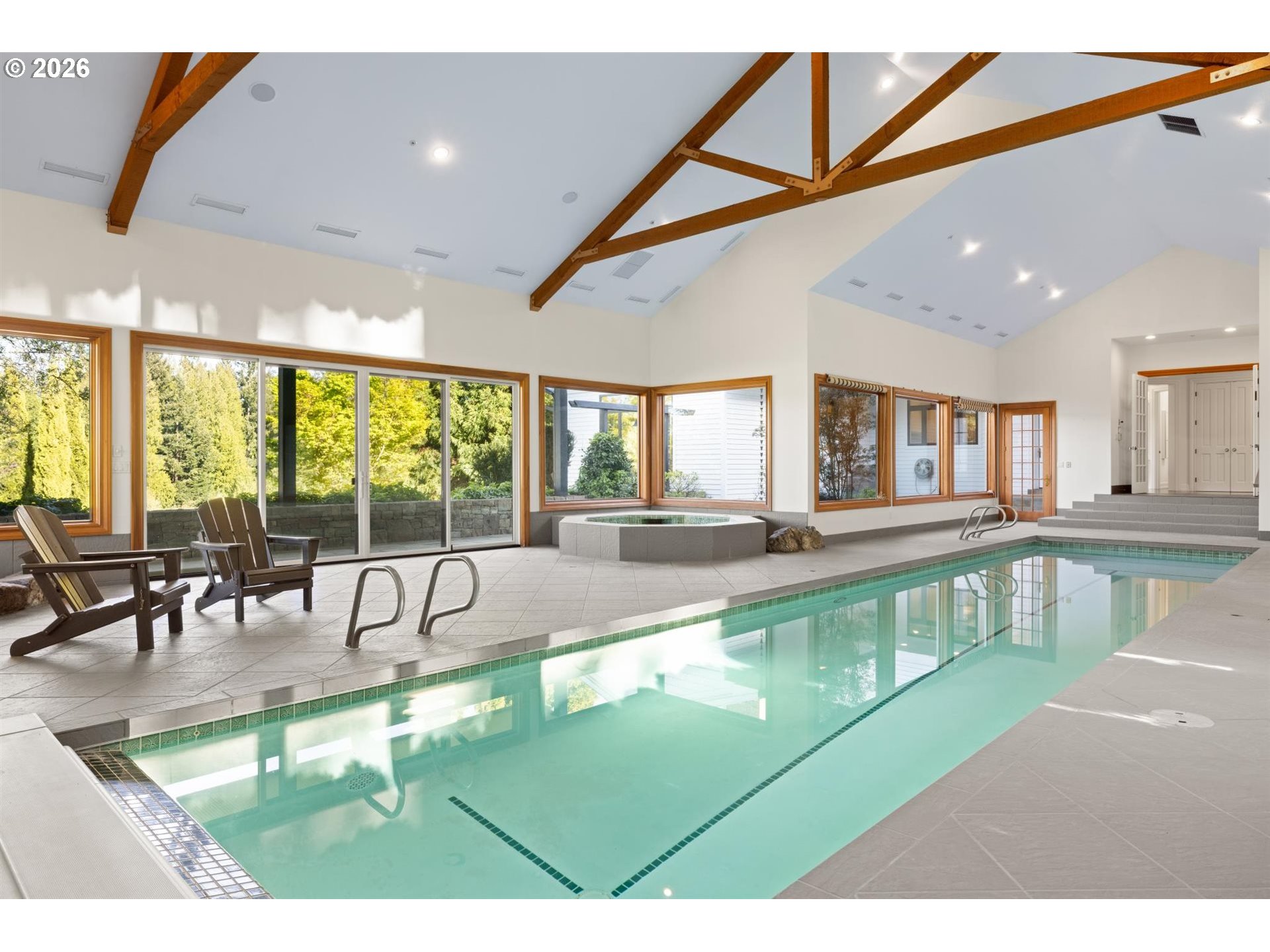 19600 Northwest 55th Avenue Ridgefield, WA 98642 - Photo 41 of 48 a view of a swimming pool with a large dining table and chairs