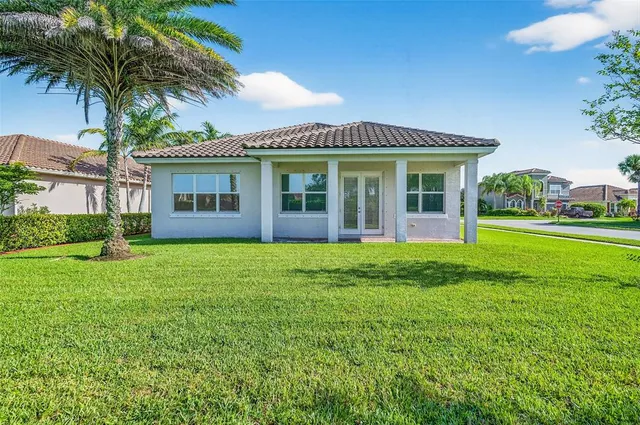 a view of a lake with a yard and outdoor seating
