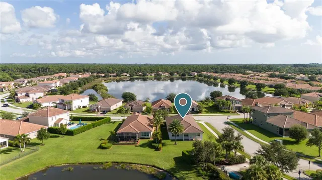 an aerial view of a house with a lake view