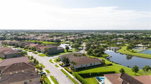 an aerial view of residential houses with outdoor space and swimming pool