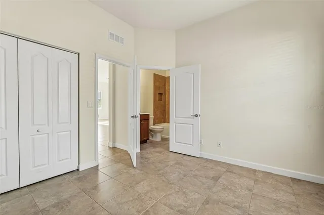 a bathroom with a granite countertop sink toilet mirror and bathtub