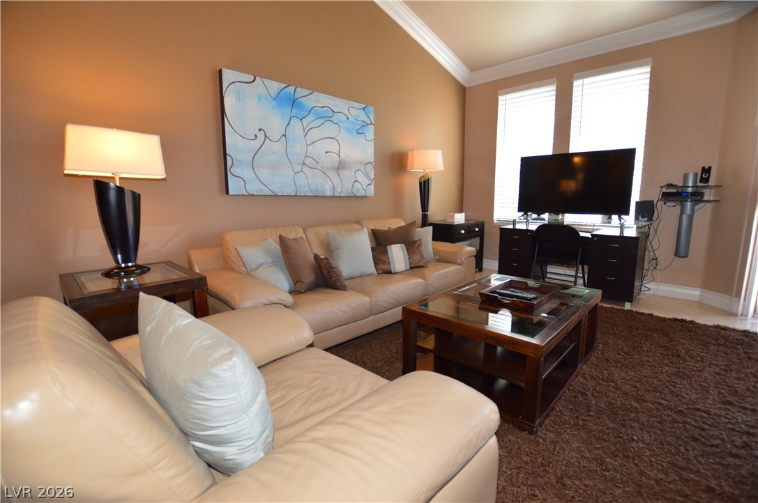 220 East Flamingo Road, Unit 327 Las Vegas, NV 89169 - Photo 13 of 13 A comfortable living space boasts soaring vaulted ceilings and a warm, inviting atmosphere.