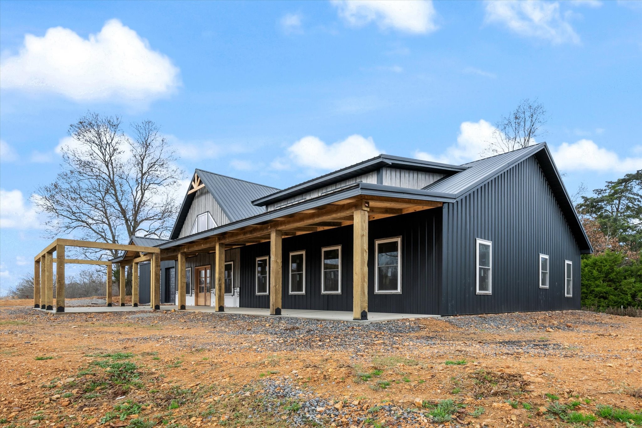5055 Pilgrims Pass Primm Springs, TN 38476 - Photo 5 of 23 a front view of a house with a yard and garage