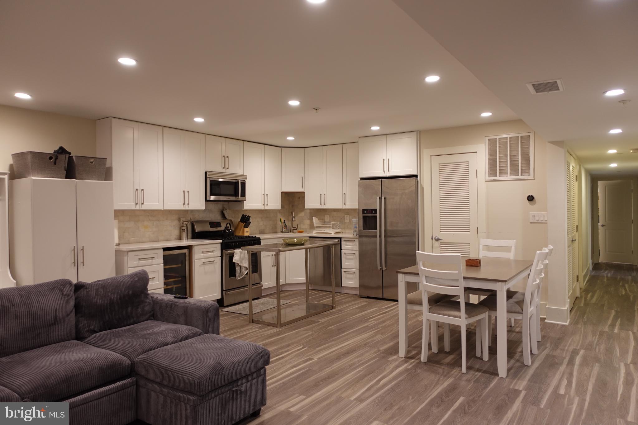 34 Channing Street Northwest, Unit 1 Washington, DC 20001 - Photo 18 of 18 a living room with stainless steel appliances furniture and a dining table with wooden floor