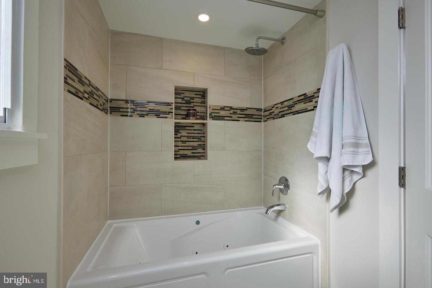 34 Channing Street Northwest, Unit 1 Washington, DC 20001 - Photo 14 of 18 a white bath tub sitting next to a shower