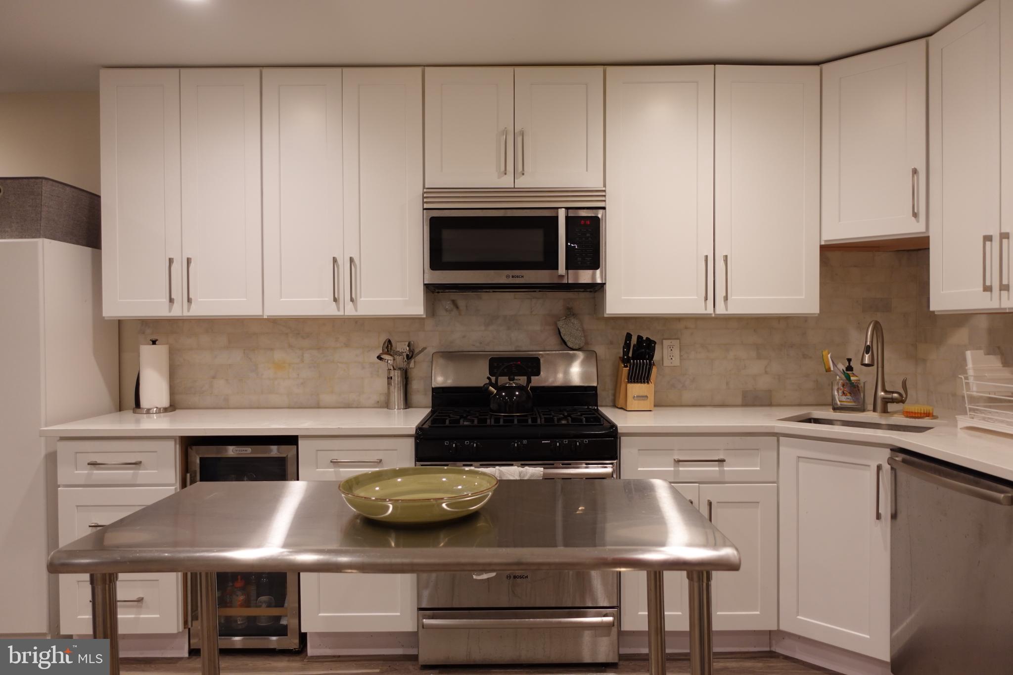 34 Channing Street Northwest, Unit 1 Washington, DC 20001 - Photo 3 of 18 a kitchen with a stove and white cabinets