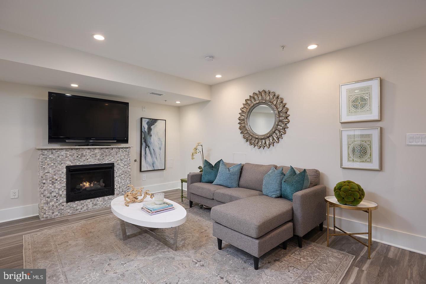 34 Channing Street Northwest, Unit 1 Washington, DC 20001 - Photo 4 of 18 a living room with furniture a fireplace and a flat screen tv