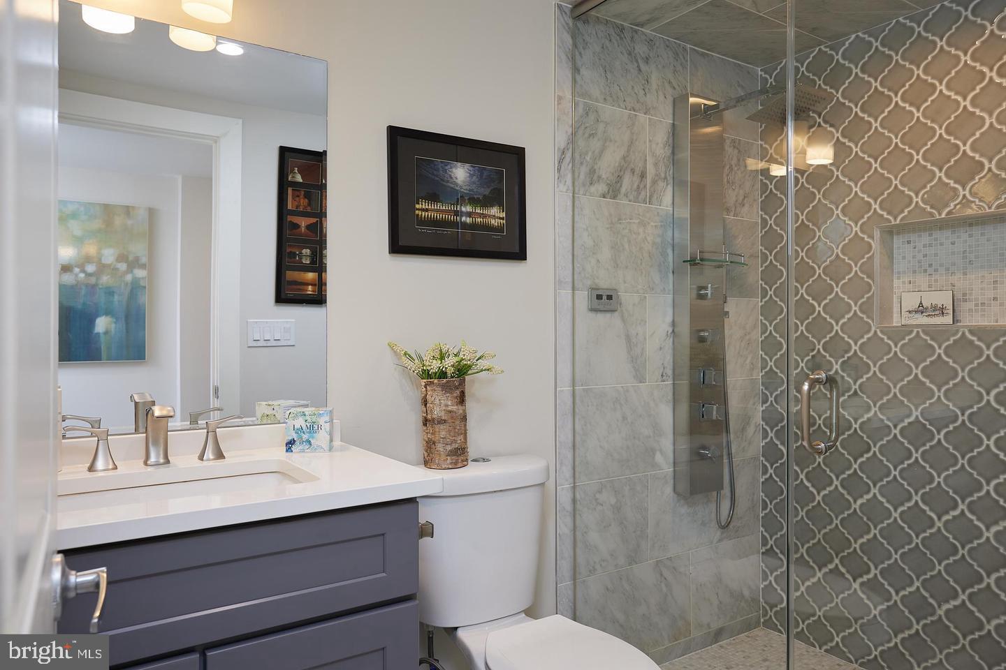34 Channing Street Northwest, Unit 1 Washington, DC 20001 - Photo 6 of 18 a bathroom with a sink mirror and toilet