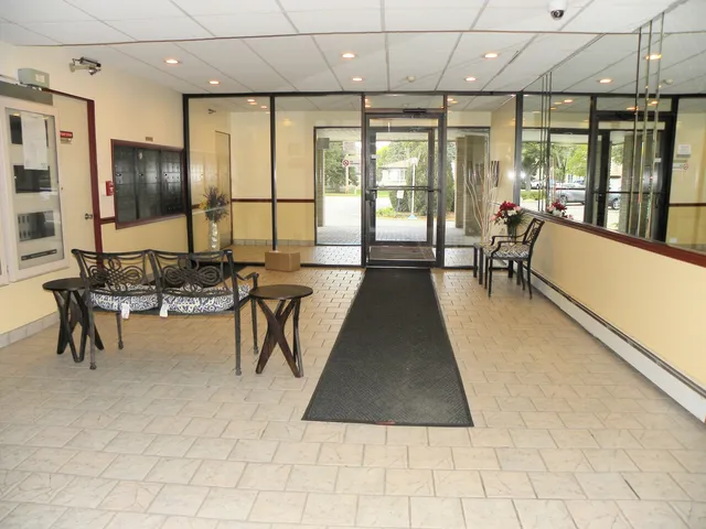 a lobby with furniture and large windows