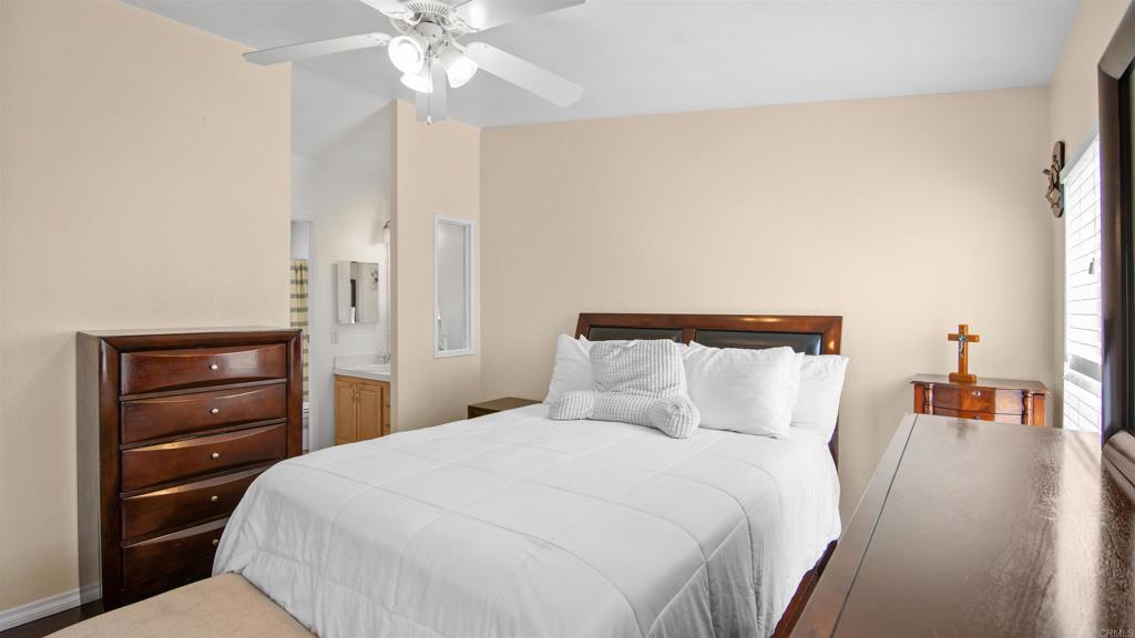 1455 Alturas Road, Unit 55 Fallbrook, CA 92028 - Photo 16 of 31 a bedroom with a bed and a chandelier