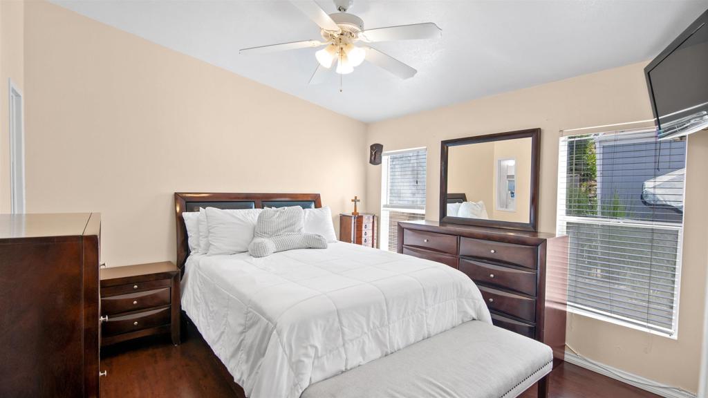 1455 Alturas Road, Unit 55 Fallbrook, CA 92028 - Photo 17 of 31 a bedroom with a large bed and a chandelier