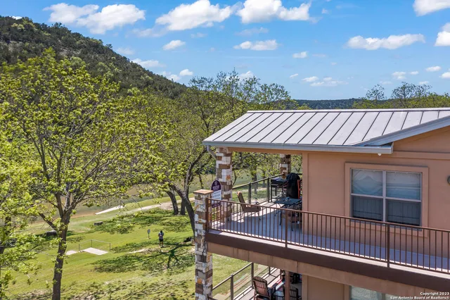 a view of a patio with table and chairs with wooden floor and fence