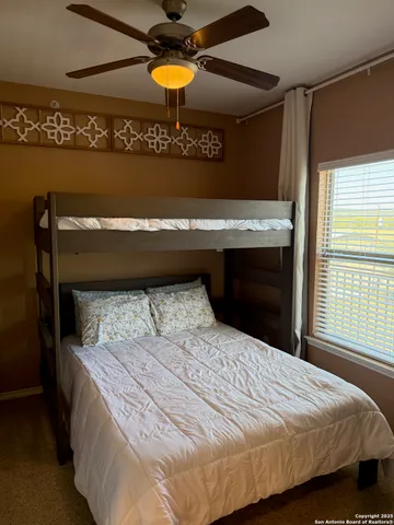 a bed sitting in a bedroom next to a window