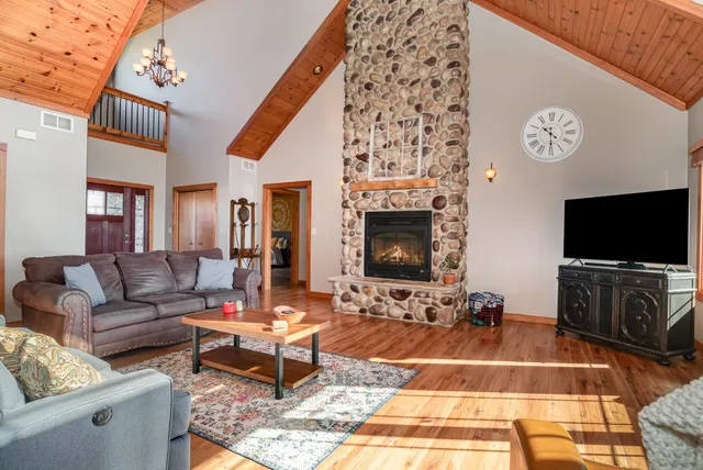 a living room with furniture flat screen tv and a fireplace