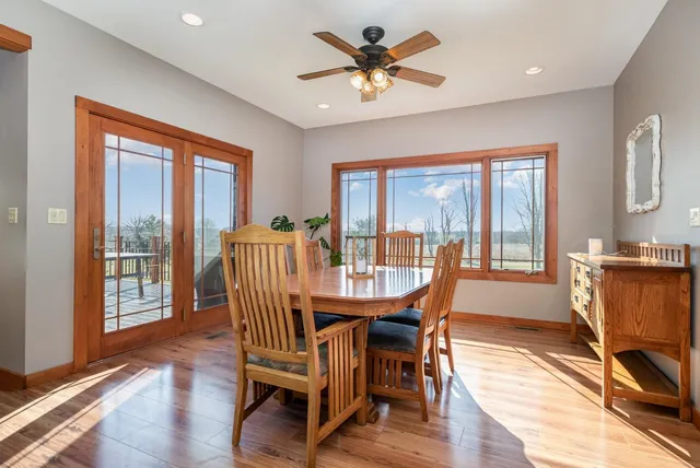 a dining room with furniture a chandelier and wooden floor