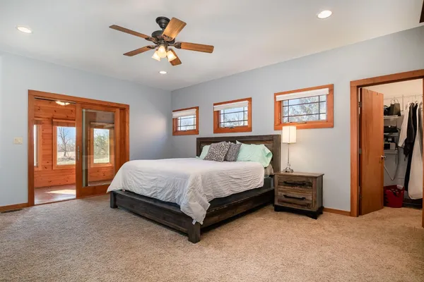 a bed sitting in a bedroom next to a window