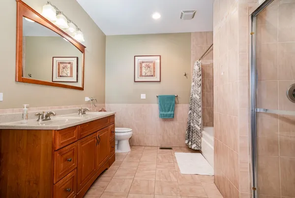 a bathroom with a sink mirror vanity and toilet