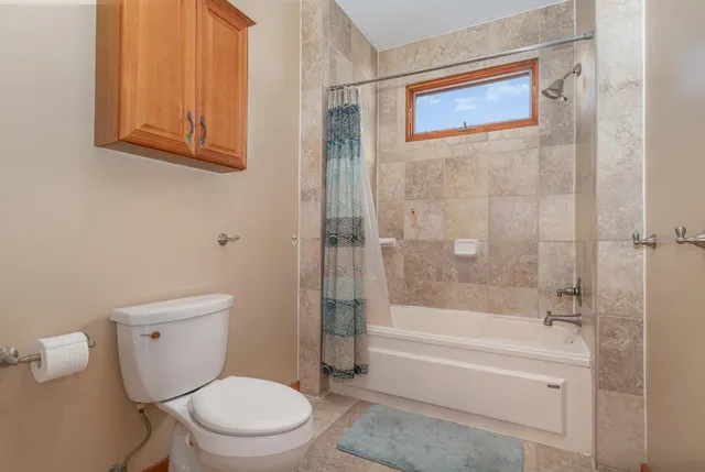 a white toilet sitting next to a bath tub