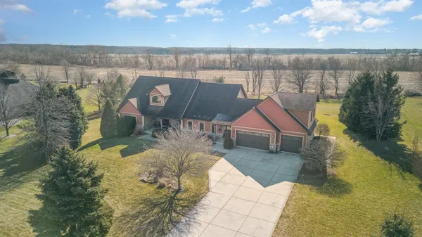 an aerial view of a house with a yard and lake view