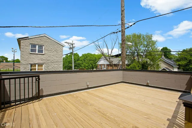 a view of a balcony with floor to ceiling windows with wooden floor