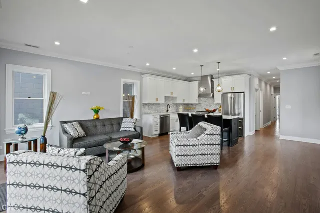 a living room with furniture and kitchen view