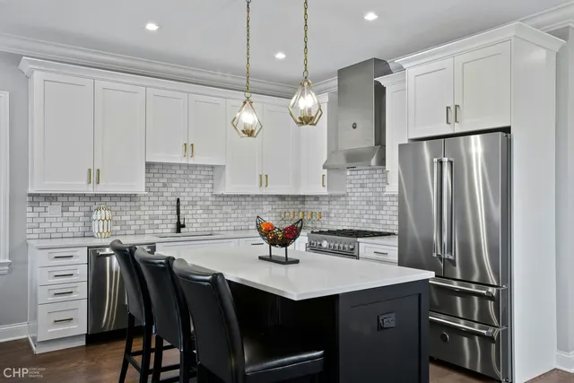 a kitchen with stainless steel appliances granite countertop a sink a stove and a refrigerator
