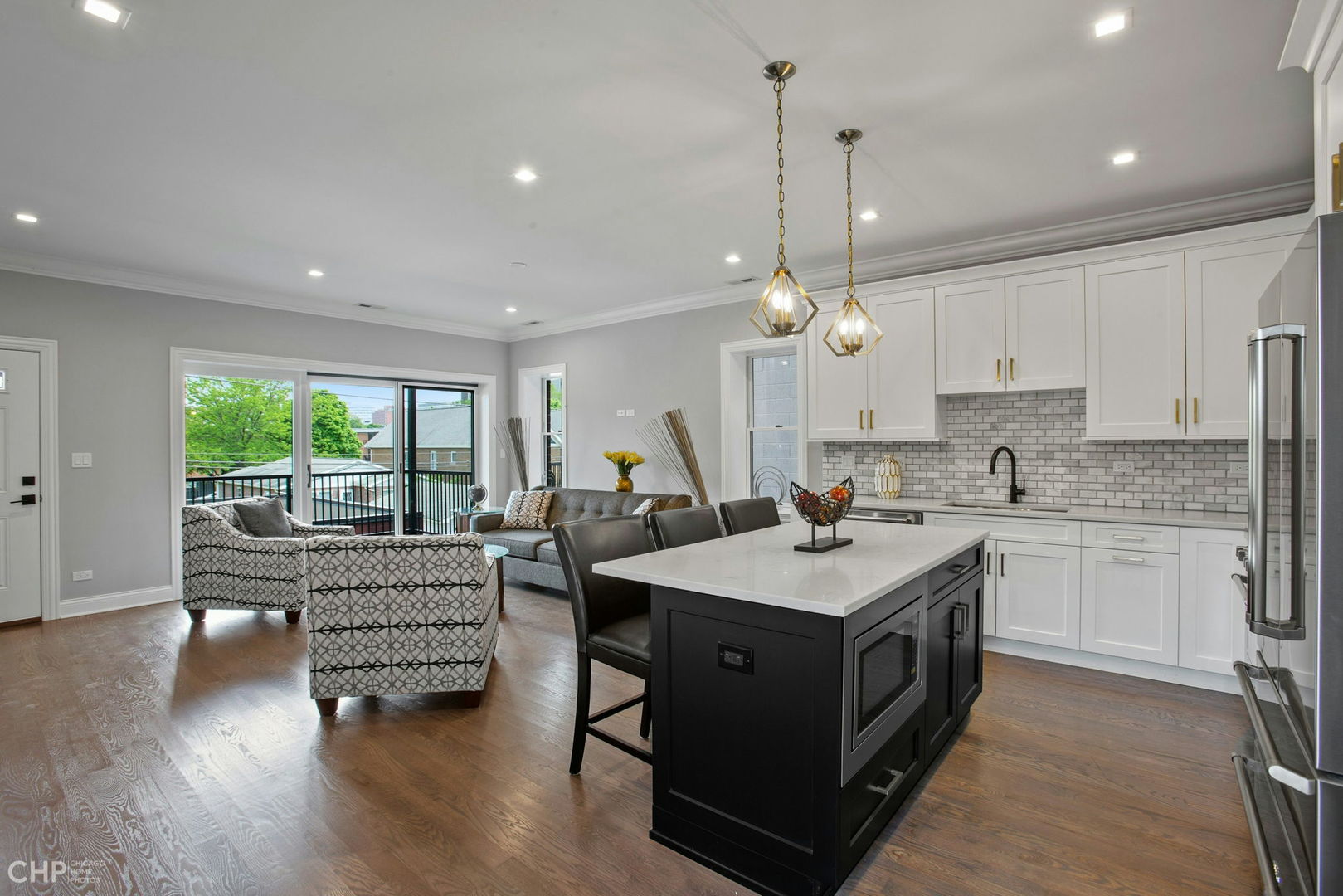 211 South Hamilton Avenue, Unit 2 Chicago, IL 60612 - Photo 4 of 16 a kitchen with a stove sink and living room view