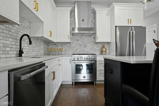a kitchen with stainless steel appliances a stove sink and refrigerator