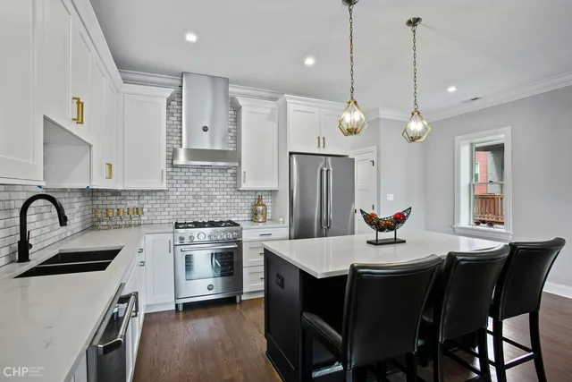 a kitchen with a dining table and chairs