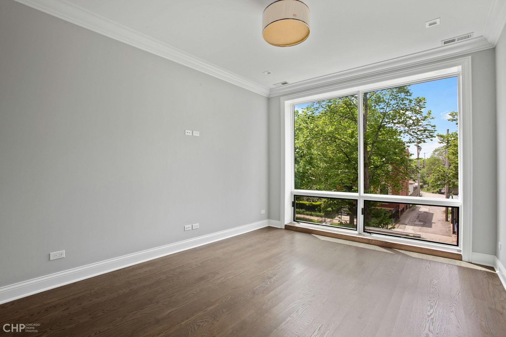 211 South Hamilton Avenue, Unit 2 Chicago, IL 60612 - Photo 8 of 16 a view of a room with wooden floor and window