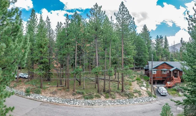 a backyard of a house with lots of green space table and chairs