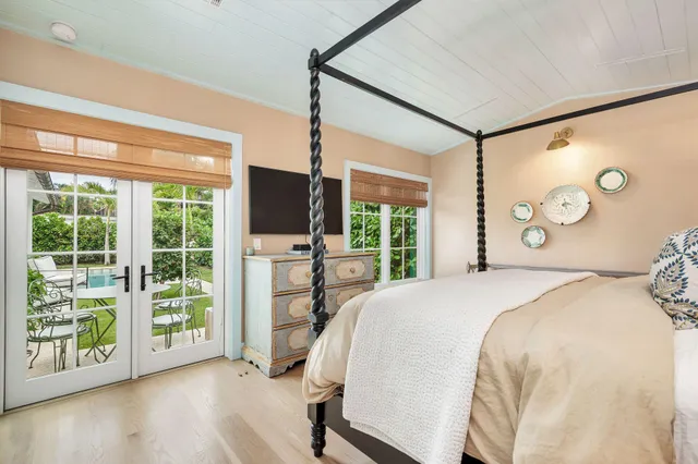 a bed sitting in a bedroom next to a window