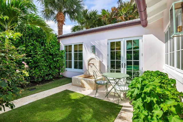a aerial view of a house with a yard and potted plants