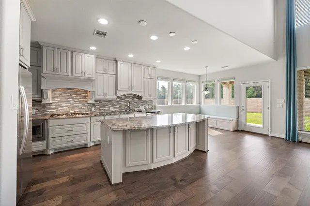a kitchen with stainless steel appliances granite countertop a stove and a sink