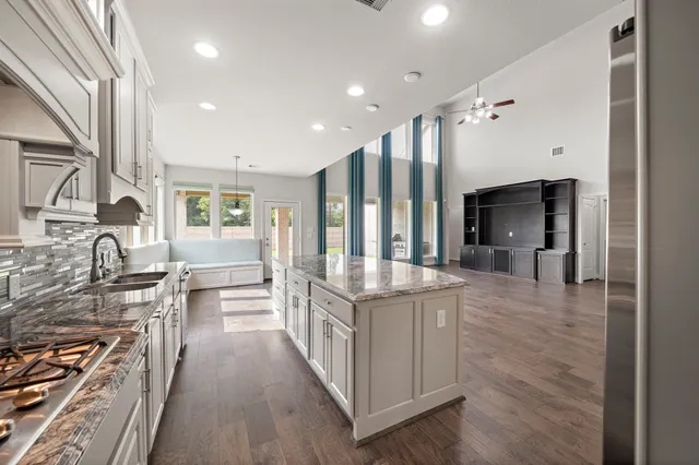 a kitchen with stainless steel appliances granite countertop a stove oven and a refrigerator