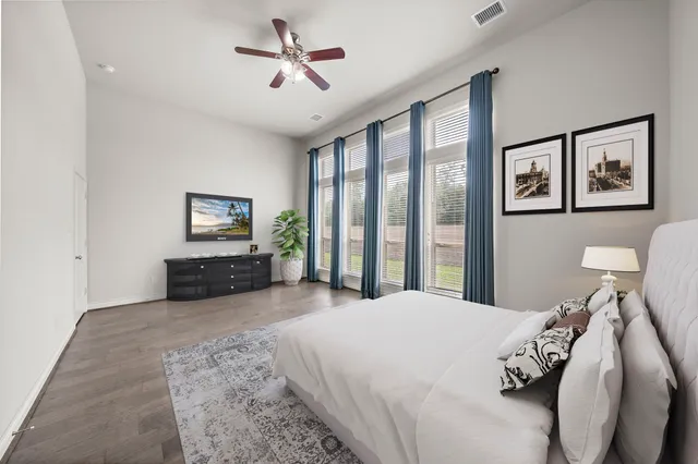 a bedroom with a large bed and a tv