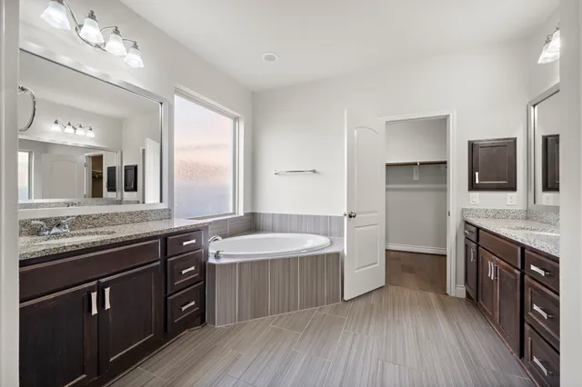 a large kitchen with a sink stove and refrigerator