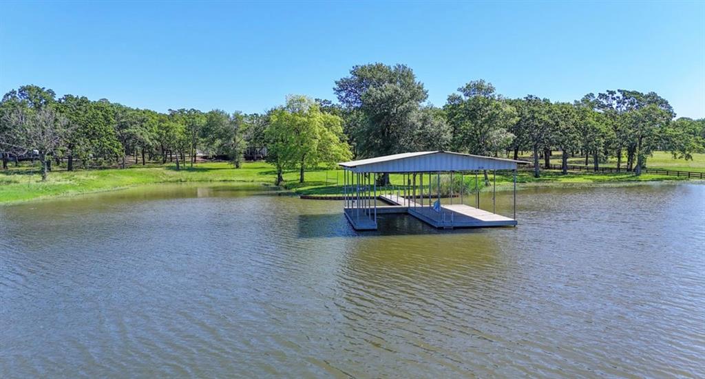 9501 Oakwood Road Quinlan, TX 75474 - Photo 23 of 34 a view of a swimming pool with an outdoor space and trees