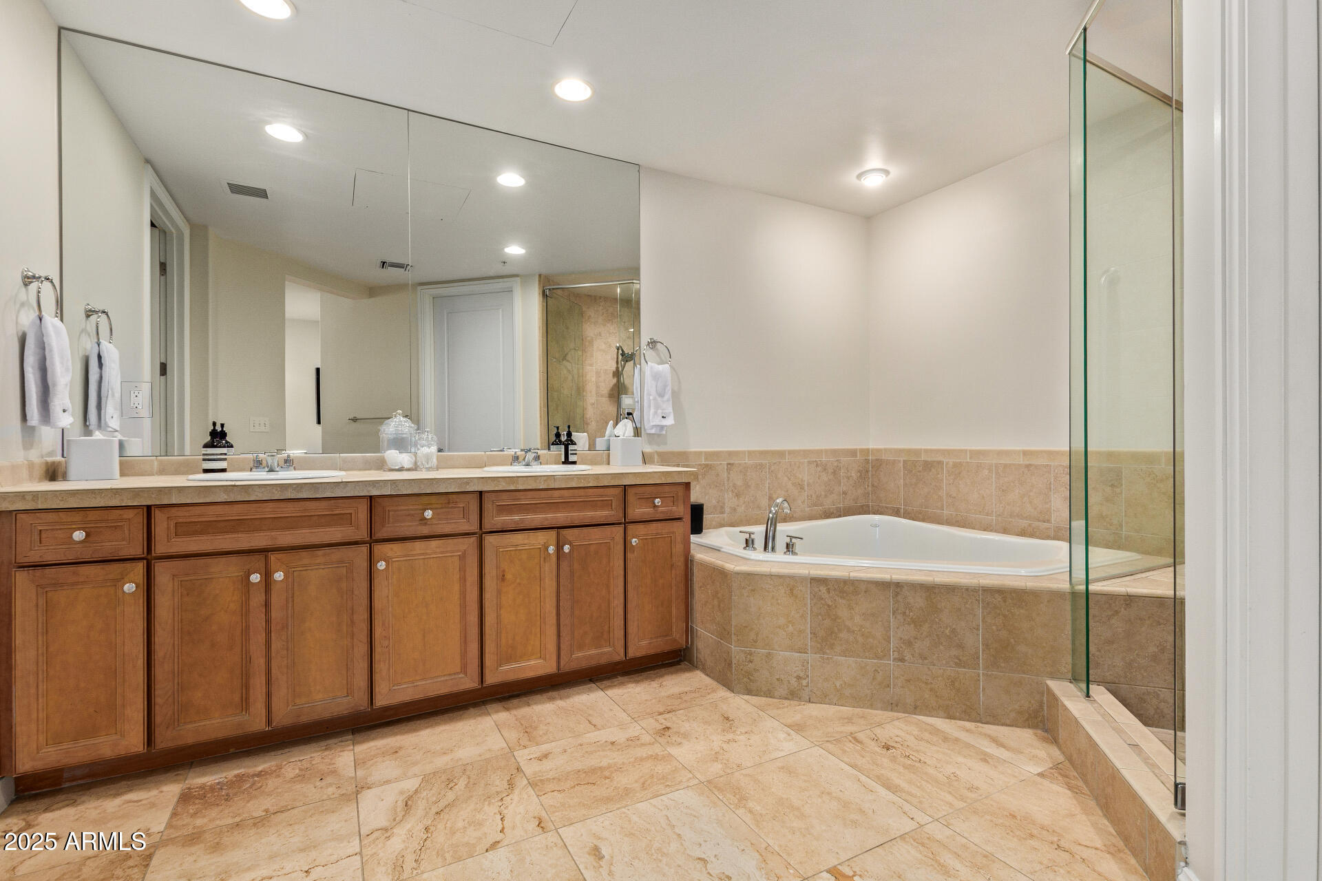 3801 North Goldwater Boulevard, Unit 302 Scottsdale, AZ 85251 - Photo 12 of 23 a bathroom with a tub a sink and a shower