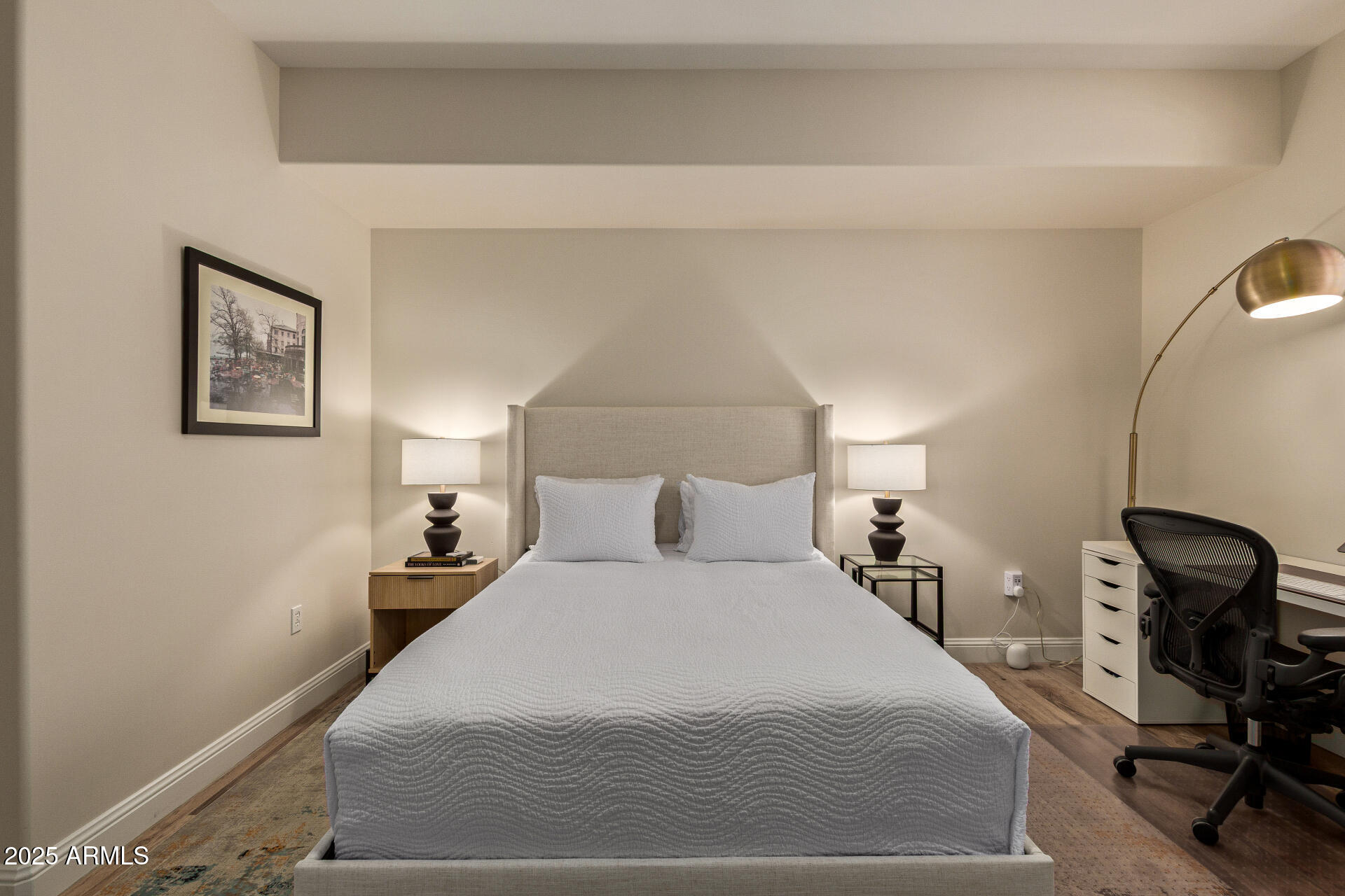 3801 North Goldwater Boulevard, Unit 302 Scottsdale, AZ 85251 - Photo 13 of 23 a bedroom with a bed and wooden floor