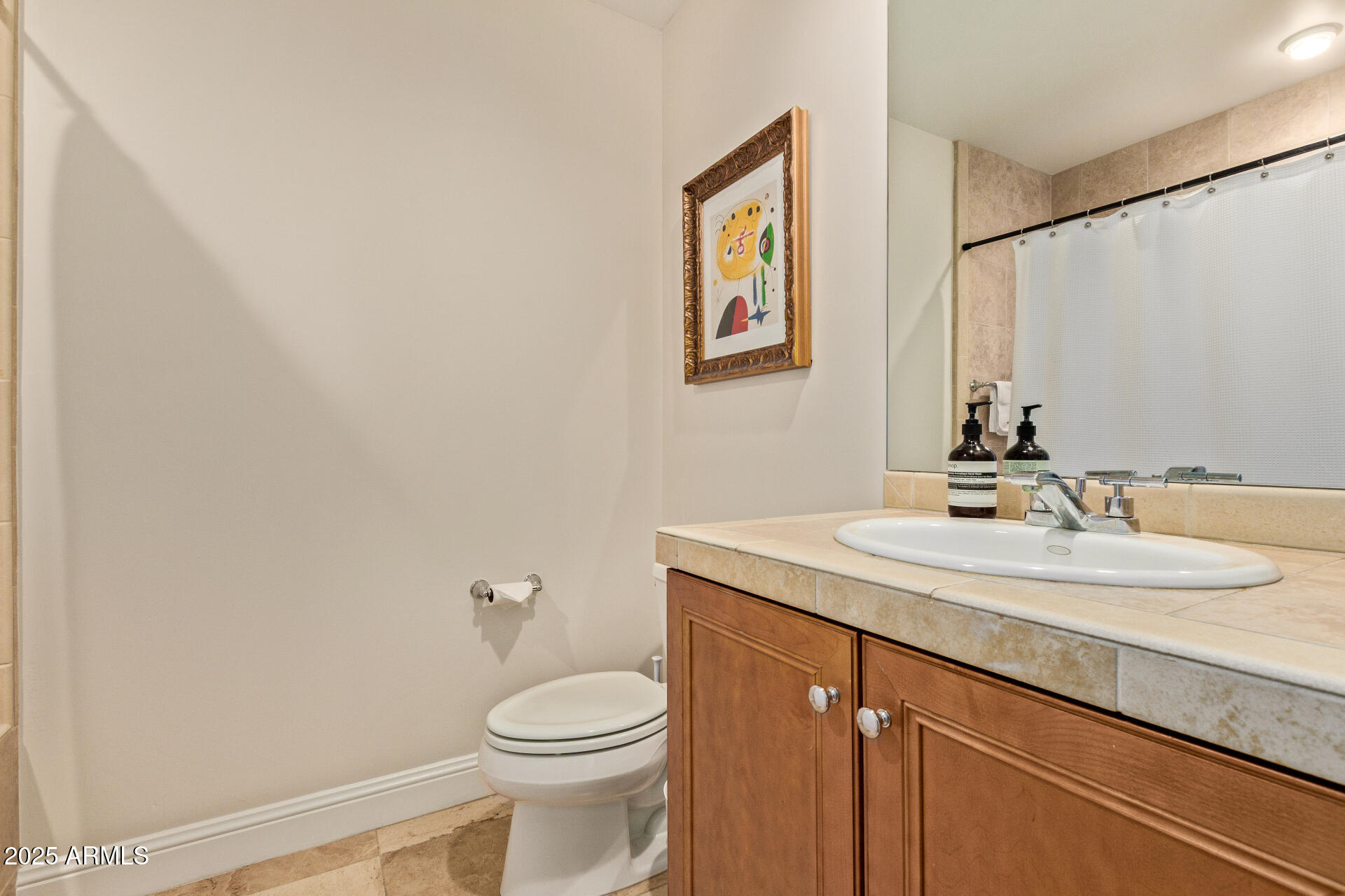 3801 North Goldwater Boulevard, Unit 302 Scottsdale, AZ 85251 - Photo 15 of 23 a bathroom with a toilet a sink and mirror