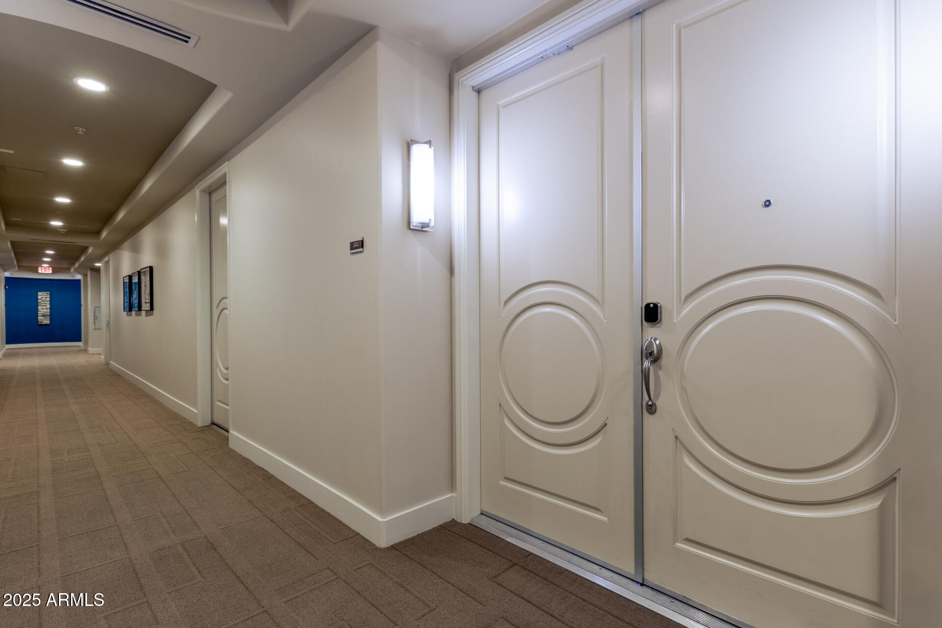 3801 North Goldwater Boulevard, Unit 302 Scottsdale, AZ 85251 - Photo 17 of 23 a bathroom with a toilet a sink and mirror