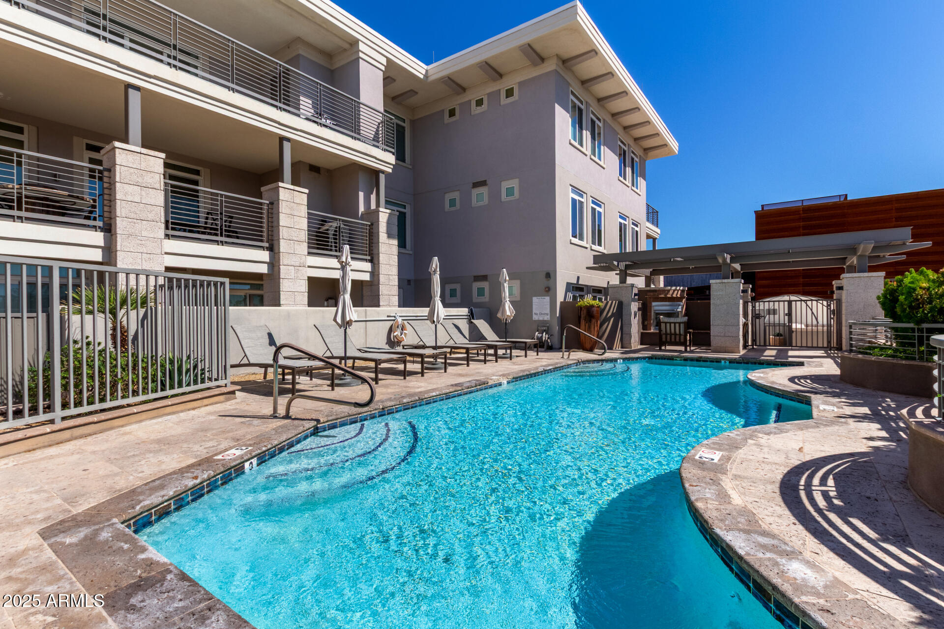 3801 North Goldwater Boulevard, Unit 302 Scottsdale, AZ 85251 - Photo 20 of 23 a view of a house with backyard porch and sitting area