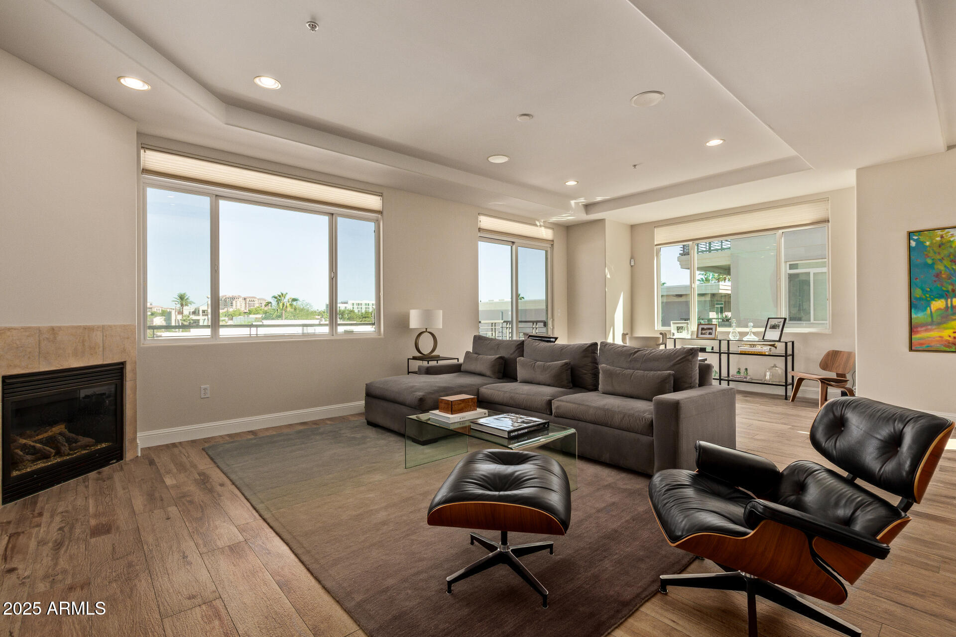 3801 North Goldwater Boulevard, Unit 302 Scottsdale, AZ 85251 - Photo 3 of 23 a living room with furniture and a fireplace