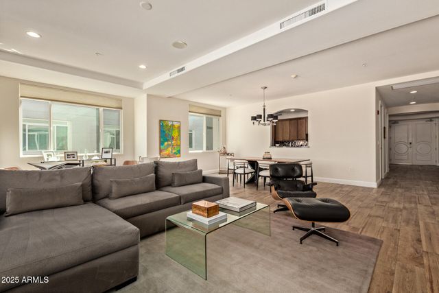 a view of a livingroom with furniture and a large window