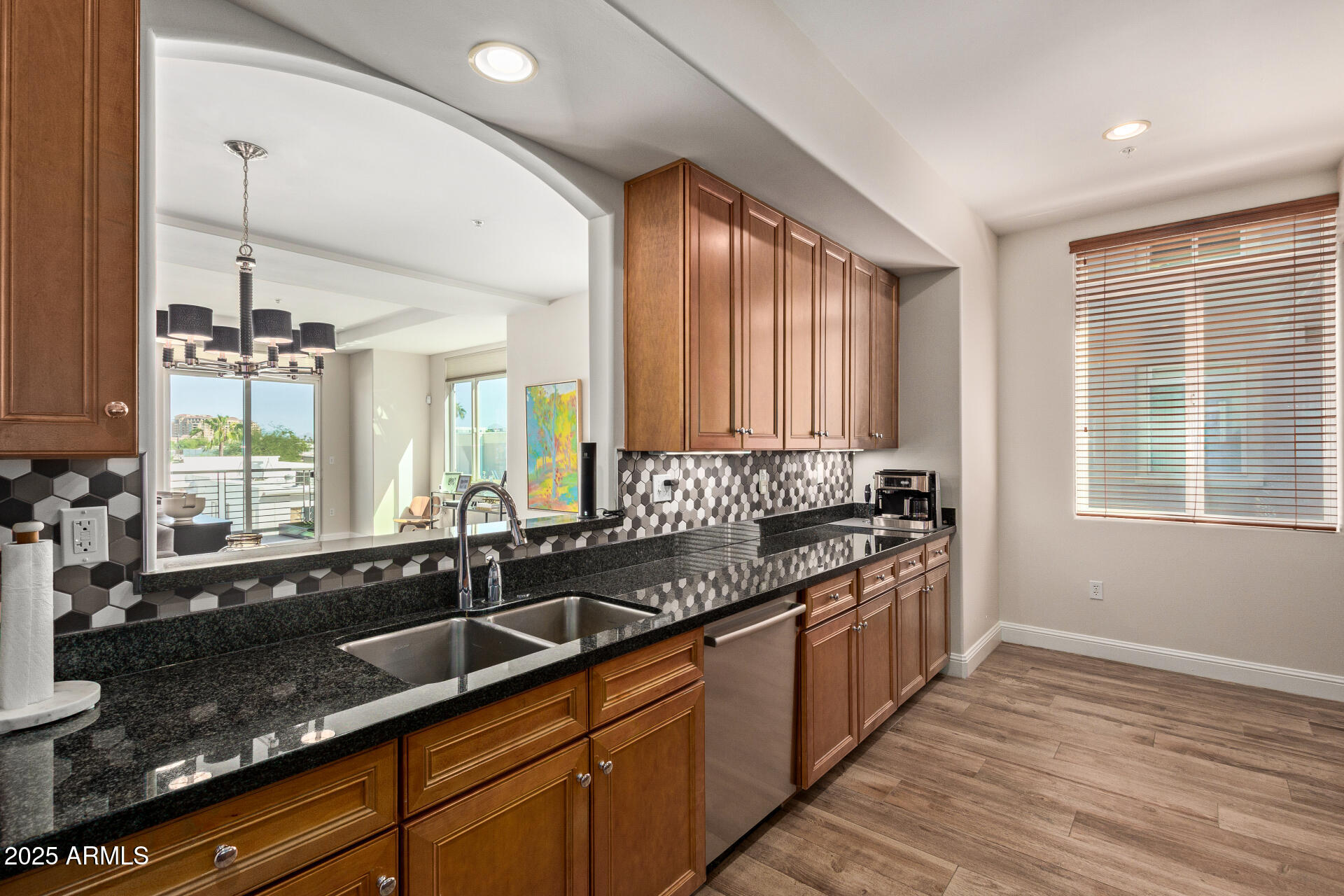 3801 North Goldwater Boulevard, Unit 302 Scottsdale, AZ 85251 - Photo 9 of 23 a kitchen with granite countertop a sink and a stove