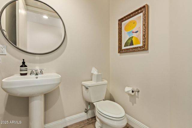 a bedroom with a bed lamp on table and a window