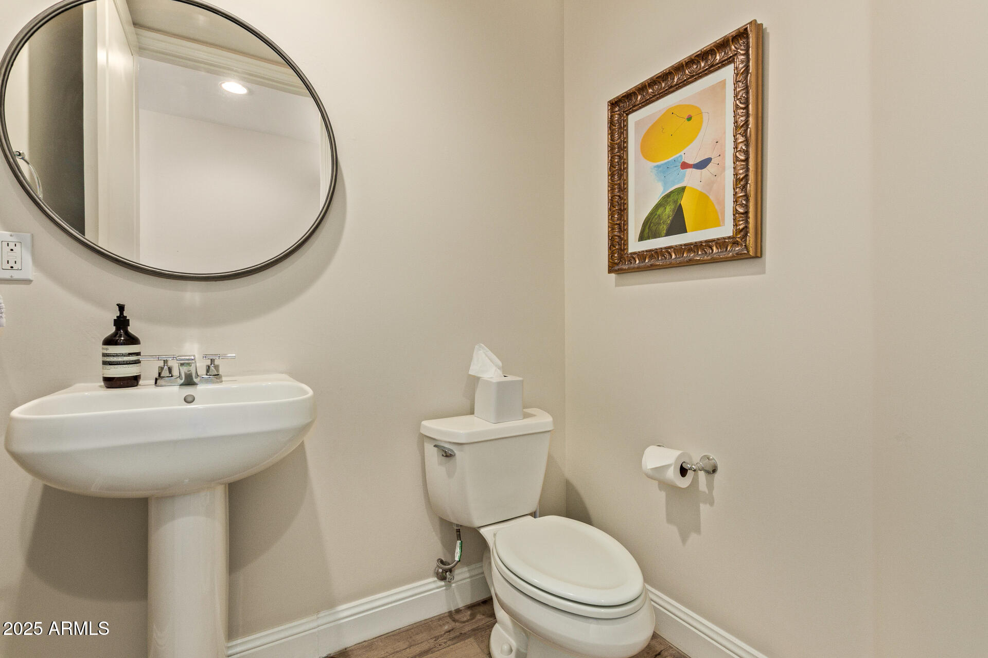 3801 North Goldwater Boulevard, Unit 302 Scottsdale, AZ 85251 - Photo 10 of 23 a bathroom with a toilet sink and mirror