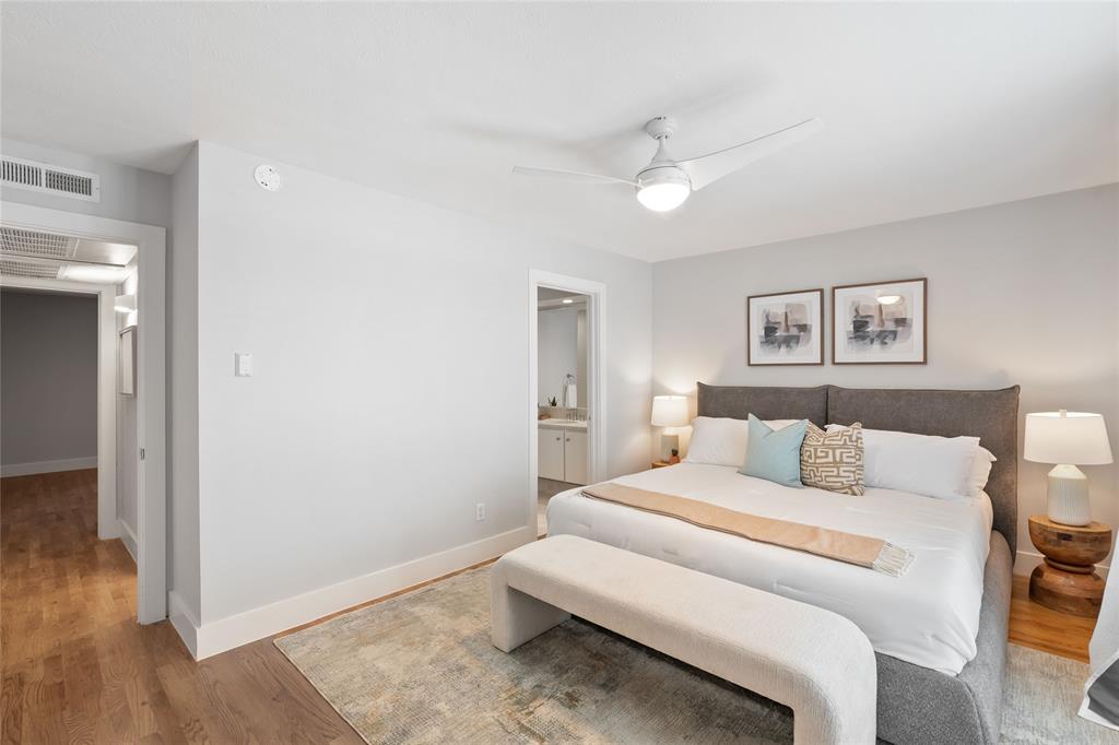 10727 Villager Road, Unit C Dallas, TX 75230 - Photo 20 of 39 Bedroom with light wood-style floors, a ceiling fan, and connected bathroom